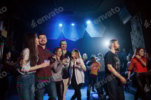 Preview: Standing at the dance floor. Beautiful youth have party together with alcohol in the nightclub