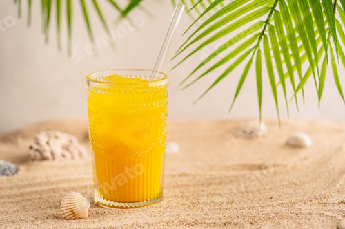 Preview: Colourful orange cocktail in a tall glass on a sand