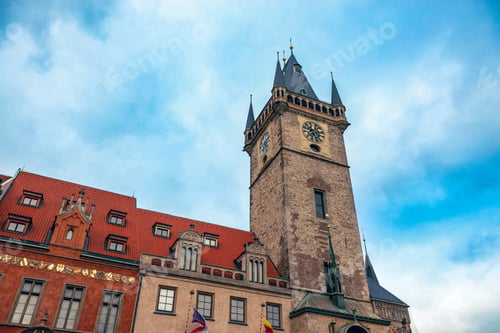 Preview: Historic clock tower in Prague under a bright blue sky during early morning hours