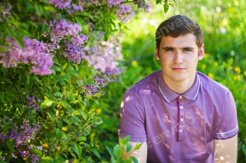 Preview: Defocus caucasian man outdoors portrait in garden. Spring people. Young men in purple shirt on natur
