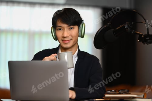 Preview: Attractive man using condenser microphone and laptop to recording audio for channel.