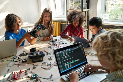 Preview: Diverse school children students build robotic cars using computers and coding.