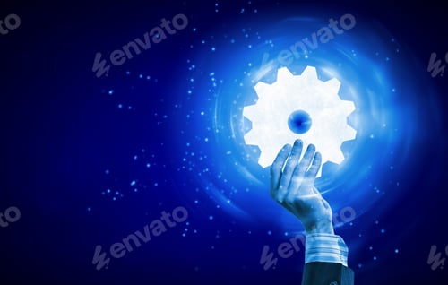 Preview: Businessperson Hand Holding Gears And Cogwheels In Palm
