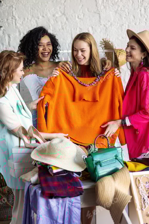 Preview: Four Women Laughing While Shopping Together