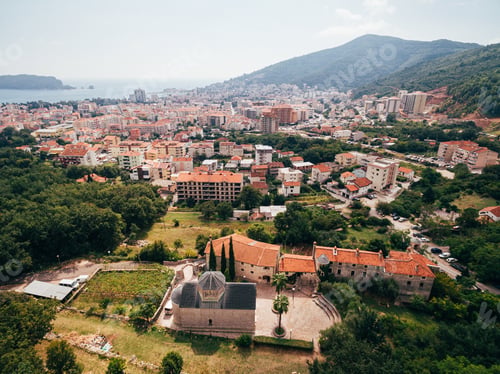 Preview: Podmaine monastery on the background of buildings. Budva, Montenegro