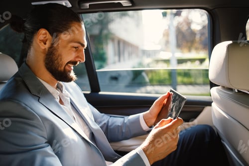 Preview: Professional Man Using Tablet in Car Interior