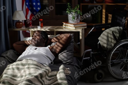 Preview: Pensive Black Man Lying Awake in His Bed at Night