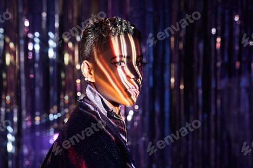 Preview: Stylish black model with shadows on face in nightclub