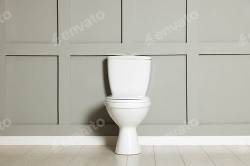 Preview: Ceramic toilet bowl near grey wall indoors
