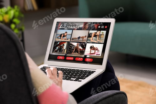 Preview: Personal trainer online. Man viewing website via laptop at home, closeup
