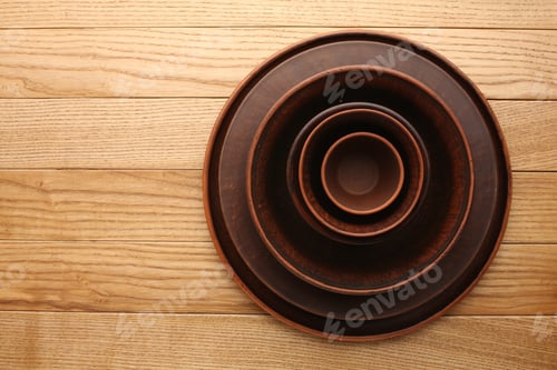 Preview: Kitchen utensils, wooden bowl, plate, dish and coasters on wooden background, Table top view