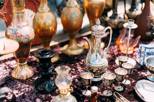 Preview: Metal Oriental Jug With Engraved Texture Floral Pattern. Oriental Style Ancient Jug At Flea Market