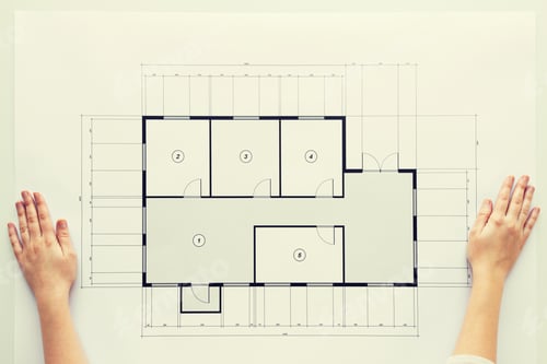 Preview: close up of hands with architectural blueprint