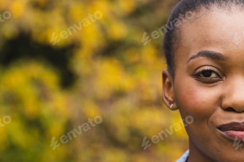 Preview: Half portrait of happy african american woman in garden smiling, copy space
