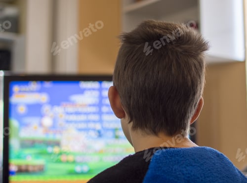 Preview: Young boy Playing Arcade Video Game on a Console at Home