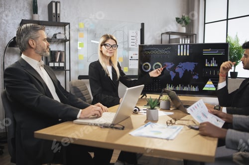 Preview: Pretty concentrated female boss leader at a meeting together with her diverse multiracial colleagues