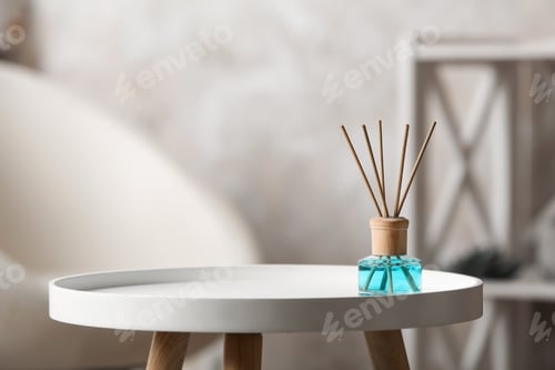 Preview: Reed air freshener on white table indoors, space for text