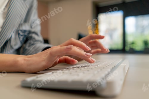 Preview: close-up of female young hands typing on white keyboard office device nude manicure professional