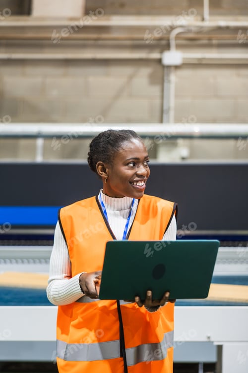 Preview: Black woman engineer managing inventory in lumberyard