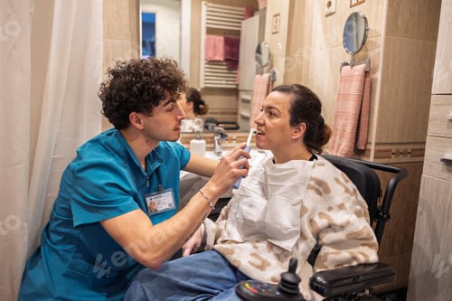 Preview: Caregiver assisting female patient with daily oral hygiene