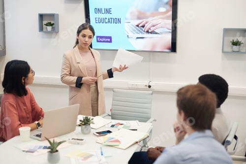 Preview: Young Woman Giving Presentation in Business Meeting