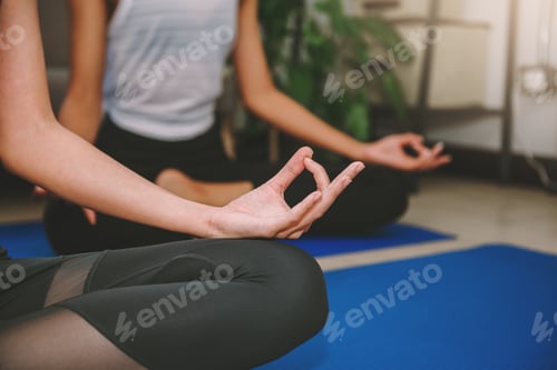 Preview: Close up woman doing yoga in lotus pose , sport and recretion concept.
