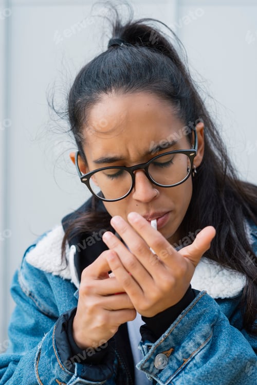 Preview: Young woman lighting cigarette