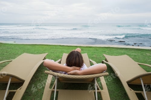Preview: caucasian woman relaxing in chair near indian ocean in Srilanka.