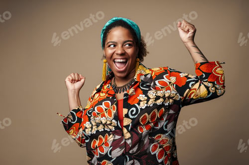 Preview: Young black woman in headband screaming and making winner gesture