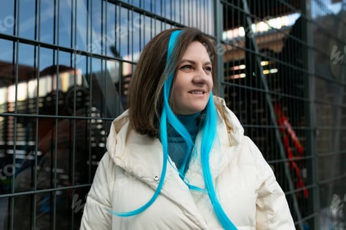 Preview: Woman With Blue Hair Standing in Front of Fence
