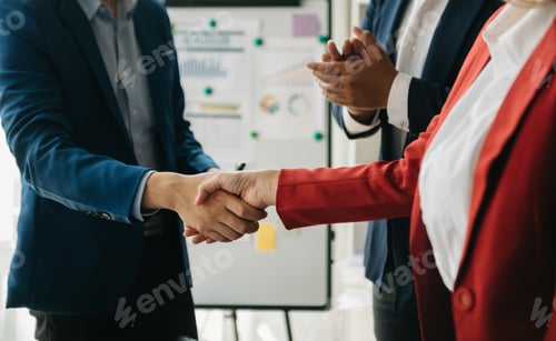 Preview: business people shaking hands during a meeting in office