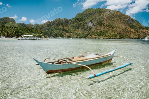 Preview: El Nido bay. Palawan island, Philippines. Filippino fishing boat in shallow water lagoon. Exotic