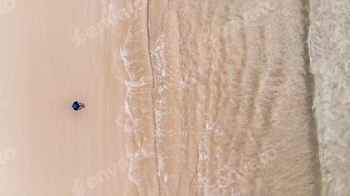 Preview: The top view of a beautiful beach with a woman is standing.