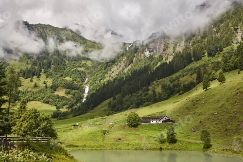 Preview: Grossglockner. Serpentine alpine road viewpoint. Green forest and waterfall. Austria