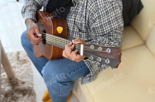 Preview: Close up of man playing acoustic guitar. Leisure activity and hobby concept