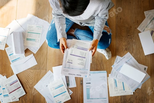 Preview: Sorting out a pile of bills on the floor