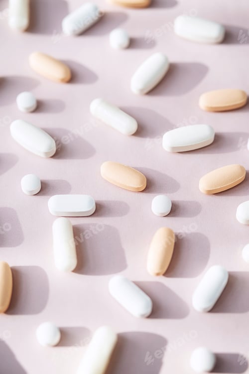 Preview: Different Pills, Vitamin Capsules on Pastel Pink Background.