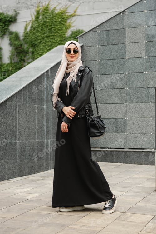 Preview: modern stylish muslim woman in hijab in city street