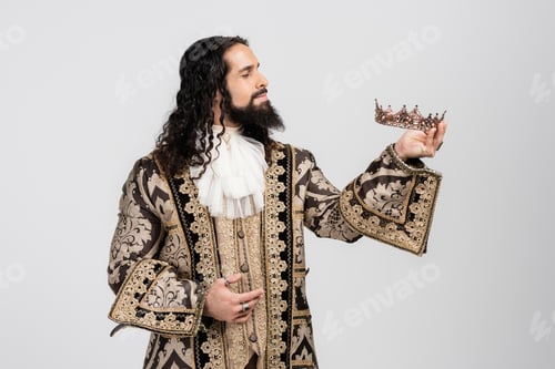 Preview: hispanic king in medieval clothing holding golden crown isolated on white