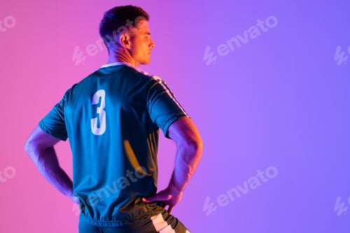 Preview: Caucasian male soccer player over neon pink lighting