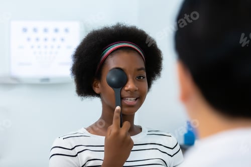 Preview: Young woman african american using occluder for eye test ophthalmological in optics clinic.