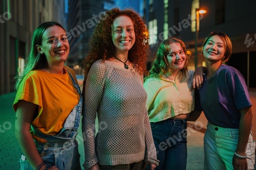 Preview: Four Smiling Young Women Enjoying a Night Out