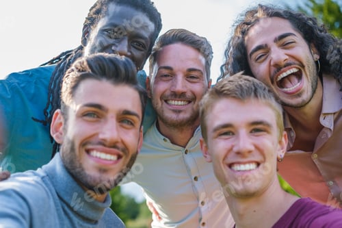 Preview: Group of young guys posing outdoors in the park while having a fun time. focus on the guys in back