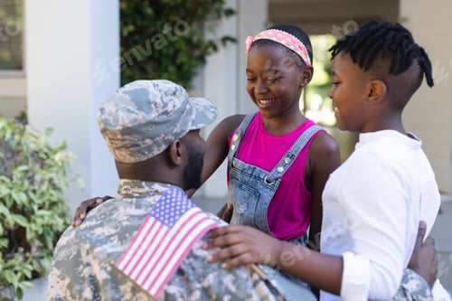 Preview: African american soldier father greeting smiling son and daughter in front of house