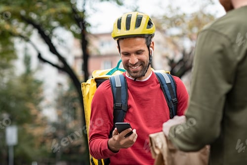 Preview: Delivery man checking food order with smartphone