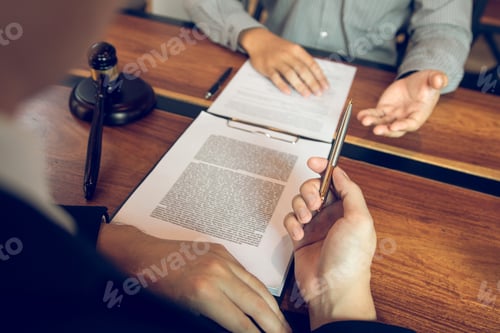 Preview: Legal advisor is explaining the offense under the law in the book at office.