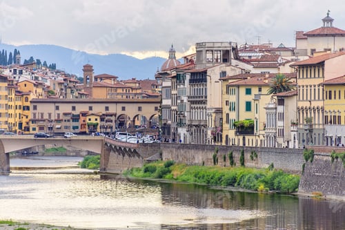 Preview: Daylight cloudy day view to Arno river with sunset reflections and cars riding on bridge