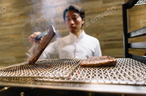 Preview: Chef cooking in restaurant preparing beef roast