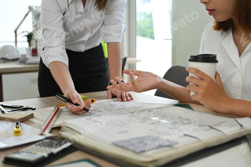 Preview: Professional team of engineers or architects, brainstorming together over joint building project
