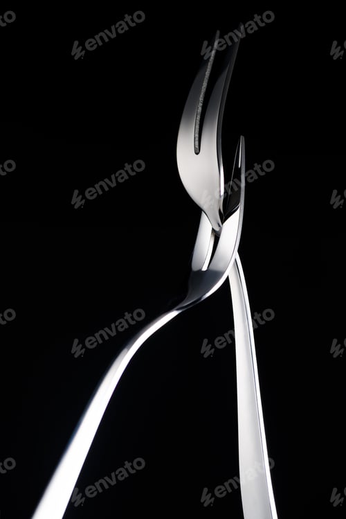 Preview: two forks with two tines isolated on black